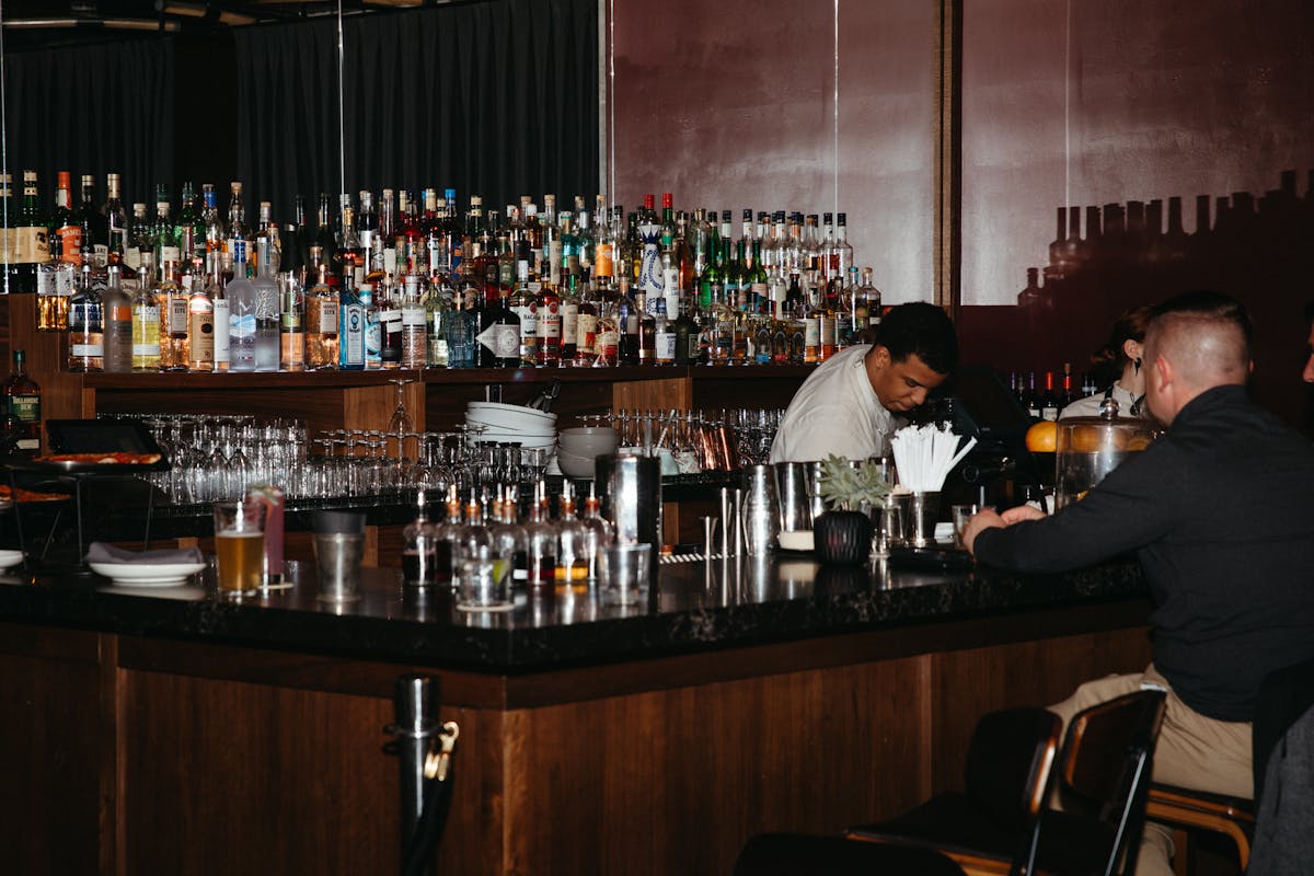 a group of people drinking wine at a bar