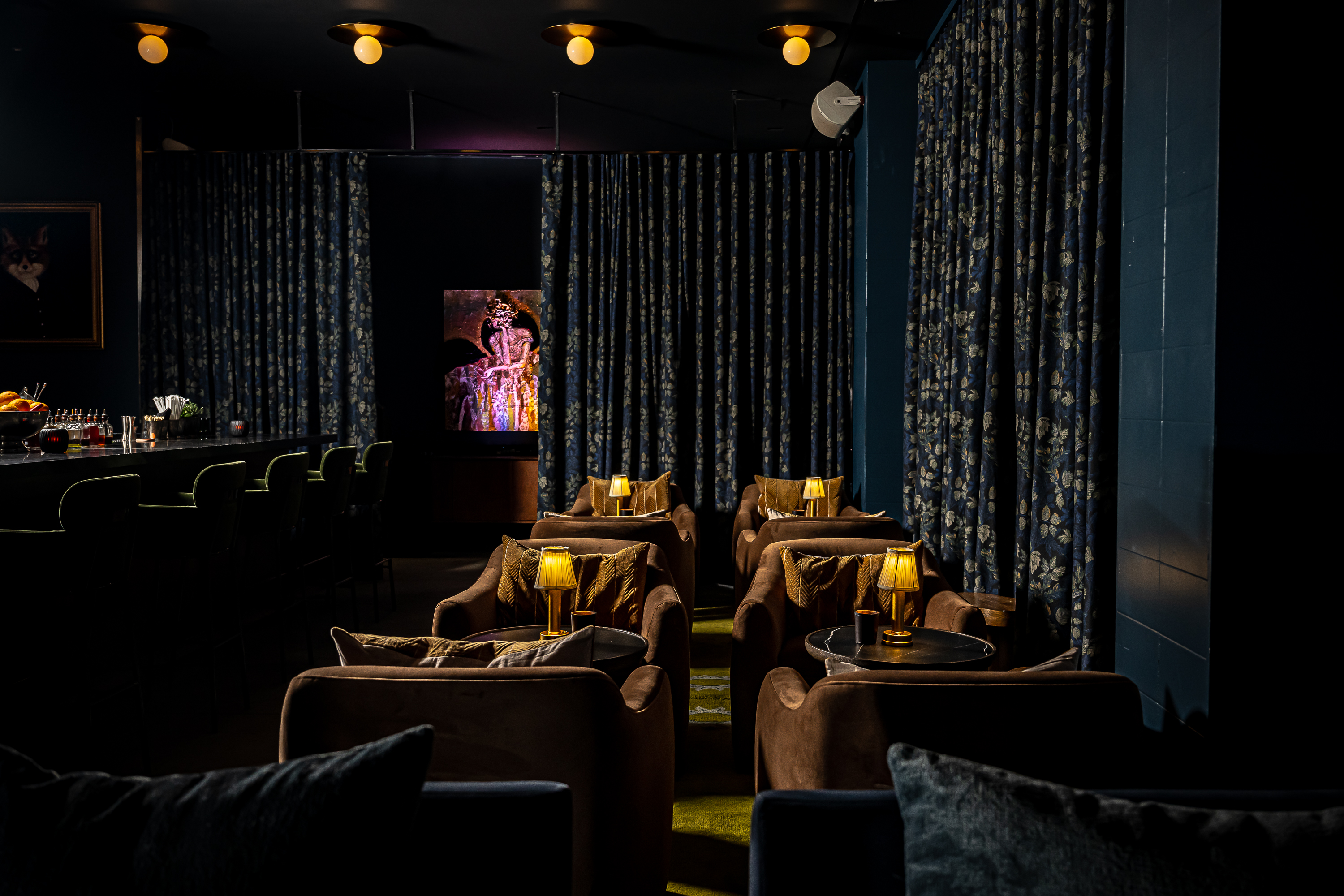 a bedroom with a bed and a chair in a dark room