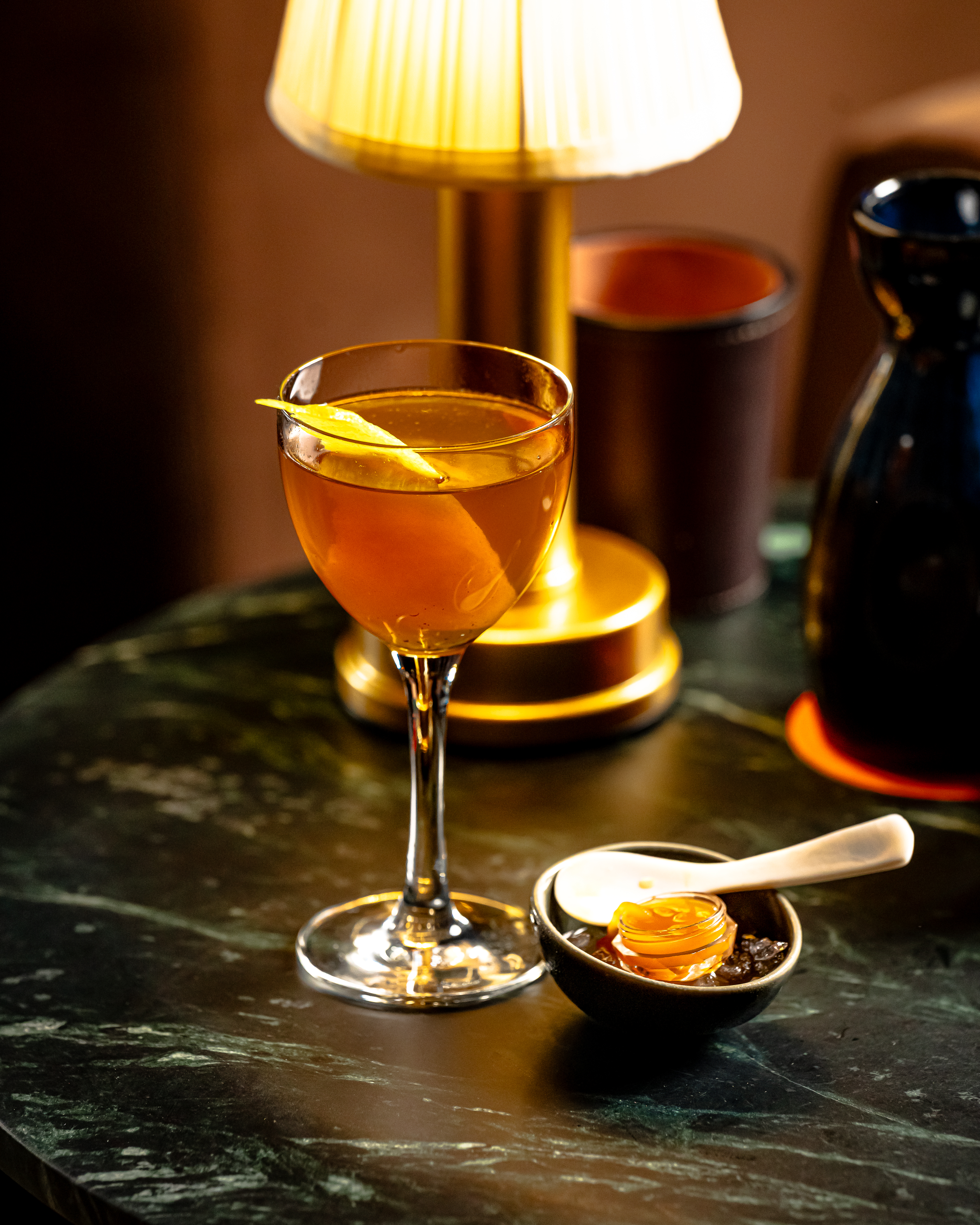 a glass of wine sitting on top of a wooden table