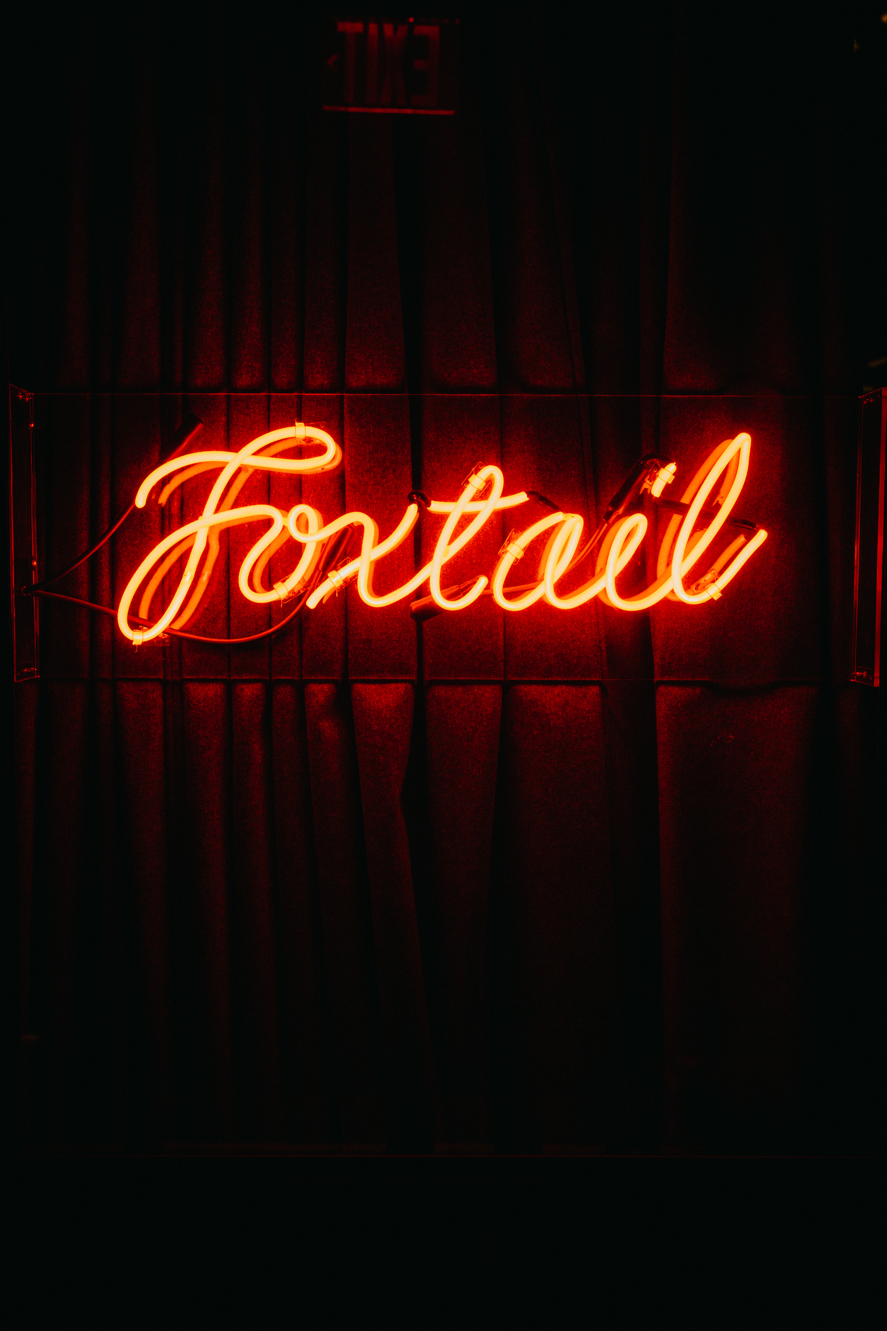 a sign lit up at night