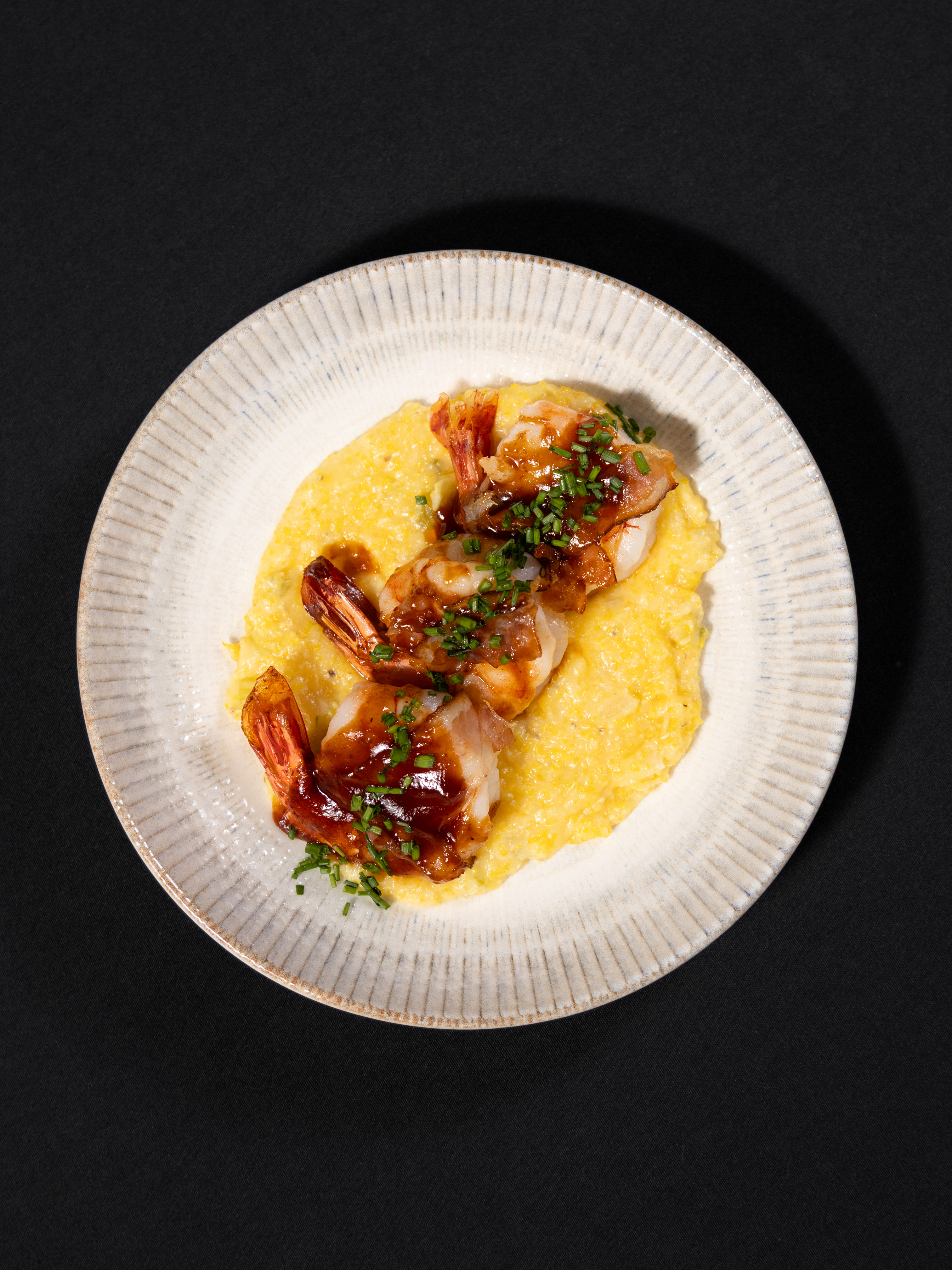 a plate of food on a black surface