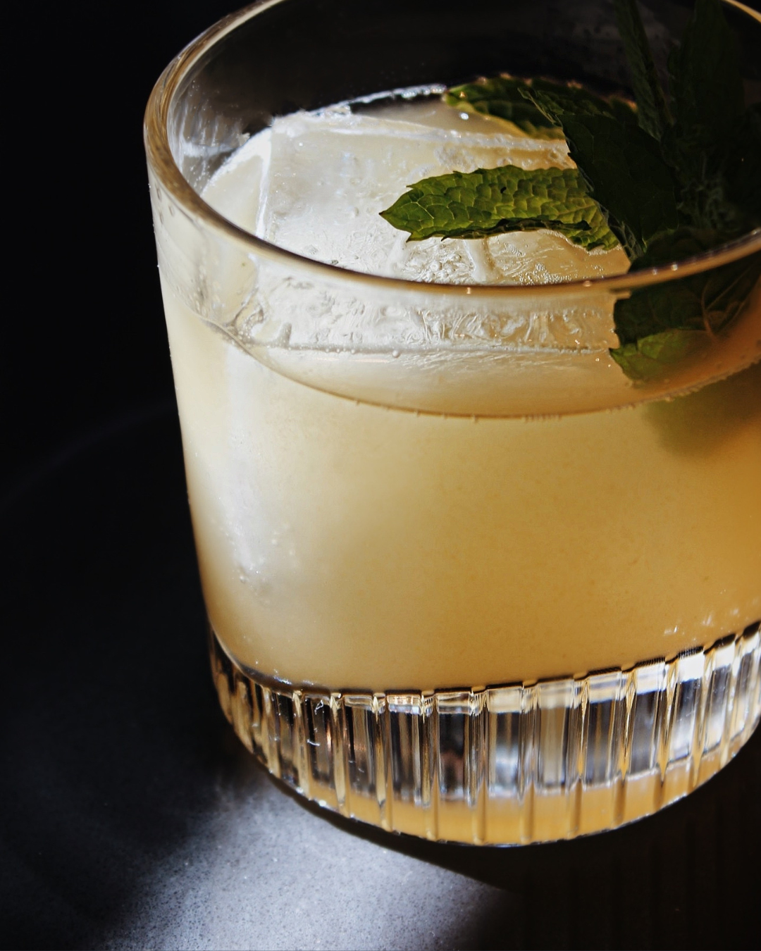 a glass with a drink and mint leaves