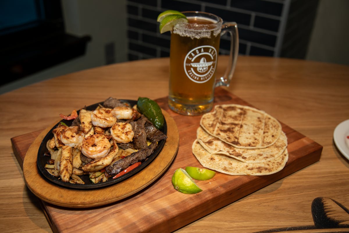 a plate of food sitting on top of a wooden cutting board