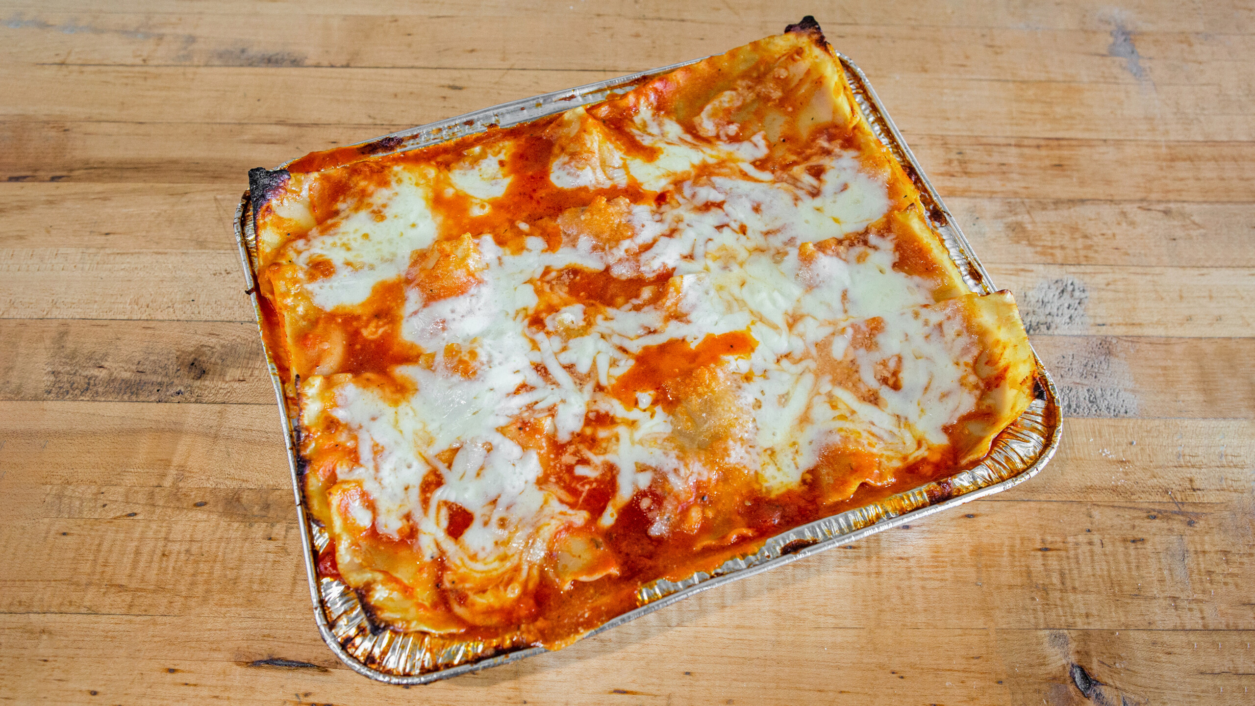 a slice of pizza sitting on top of a wooden cutting board