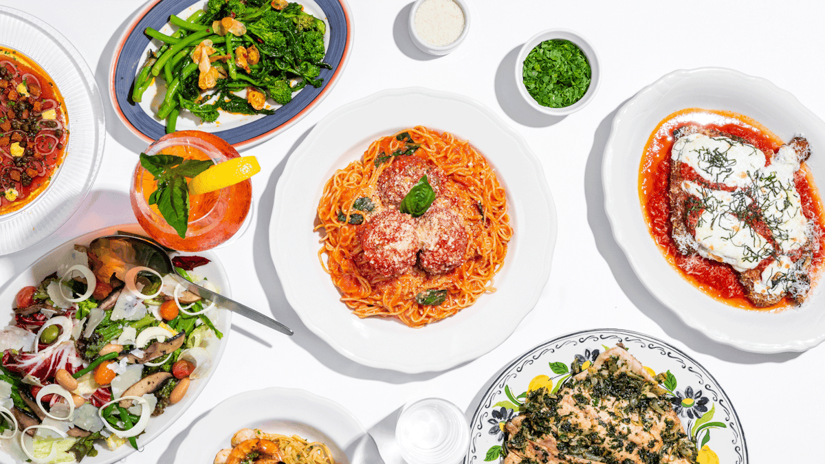 Various plates of Italian-American food on a white background