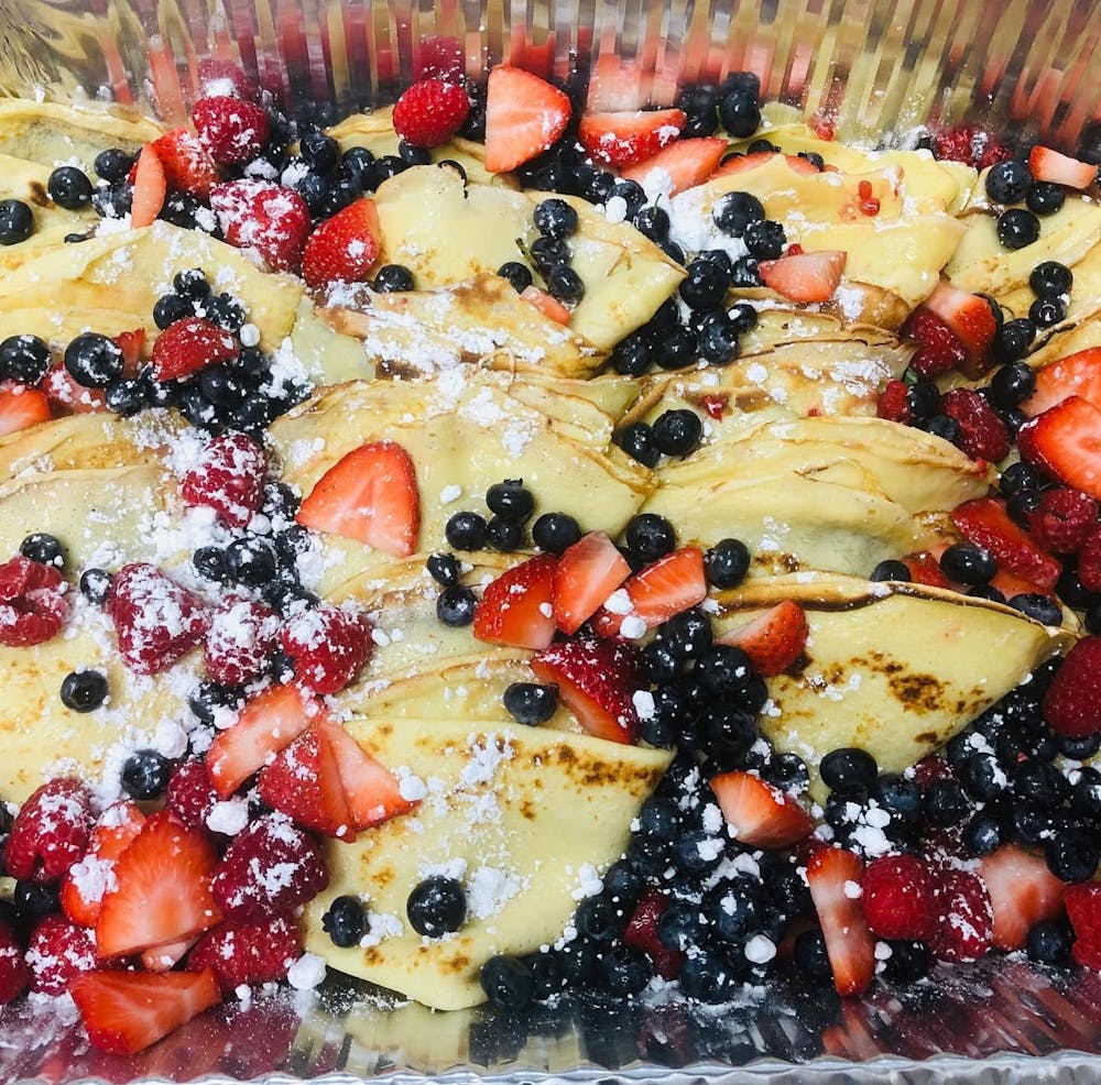 a pizza with cheese and broccoli