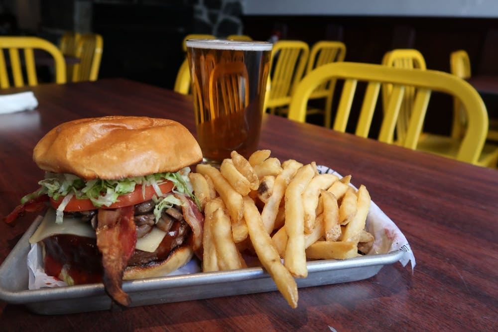 a close up of a sandwich and fries on a plate