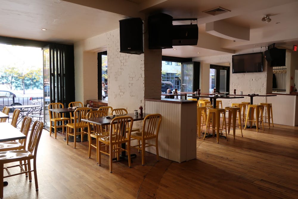 a dining room filled with furniture and a large window