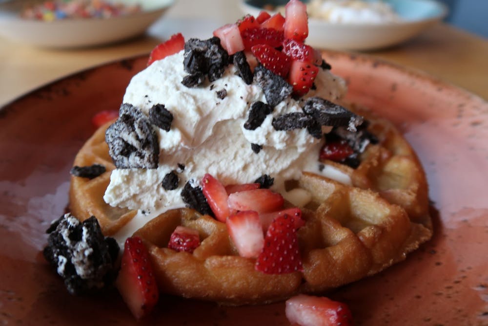 a close up of a slice of cake and ice cream on a plate