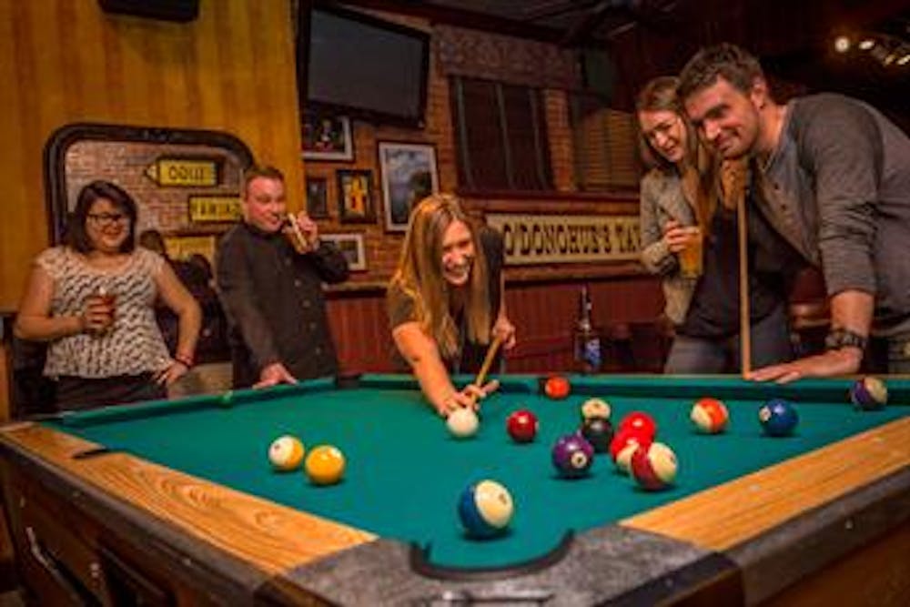 a group of people sitting at a table with a ball in a room