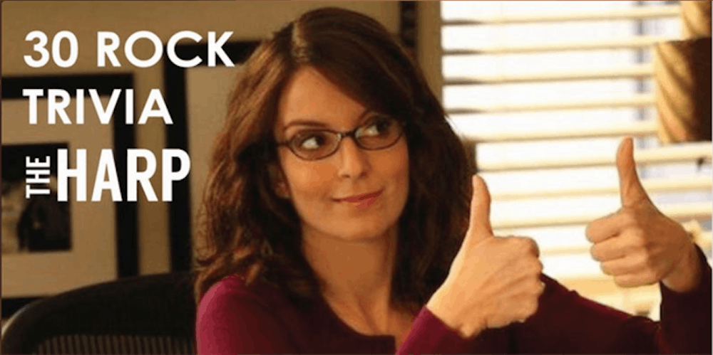 Tina Fey sitting on a table