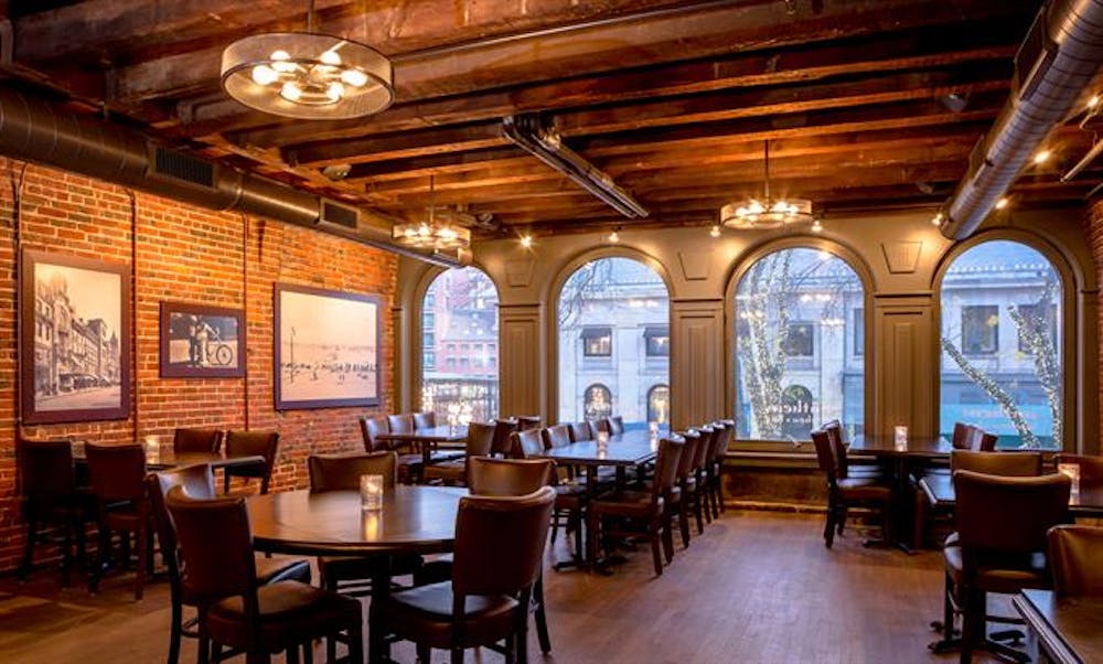 a dining room filled with furniture and a large window