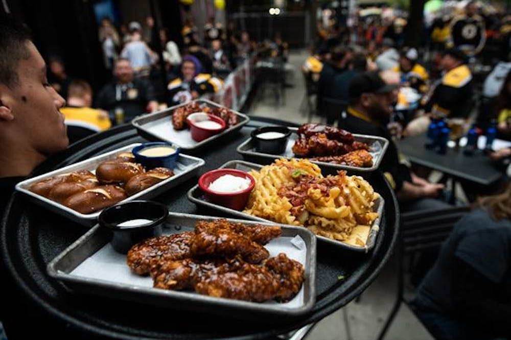 a group of people sitting at a table with a plate of food