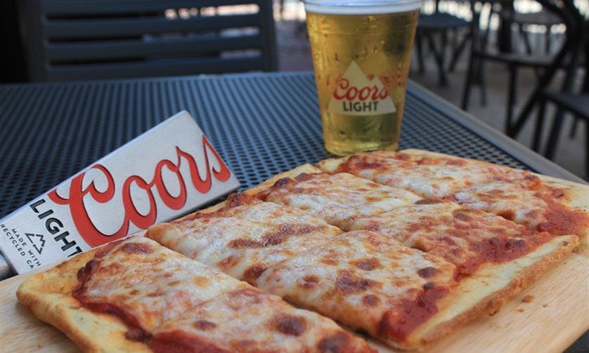 a slice of pizza sitting on top of a table