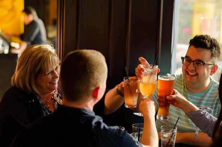 a group of people sitting at a table with wine glasses