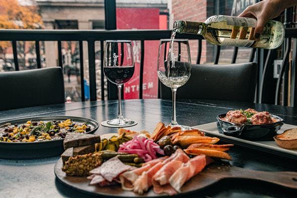 a group of people sitting at a table with a plate of food