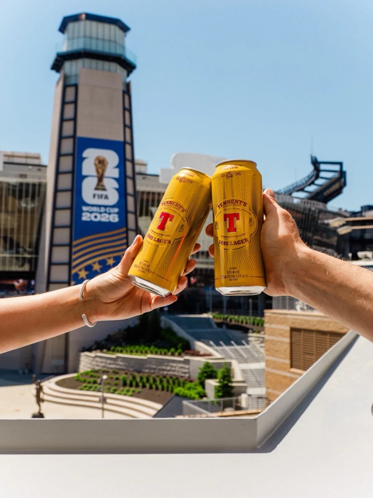 a couple of hands holding cans of beer