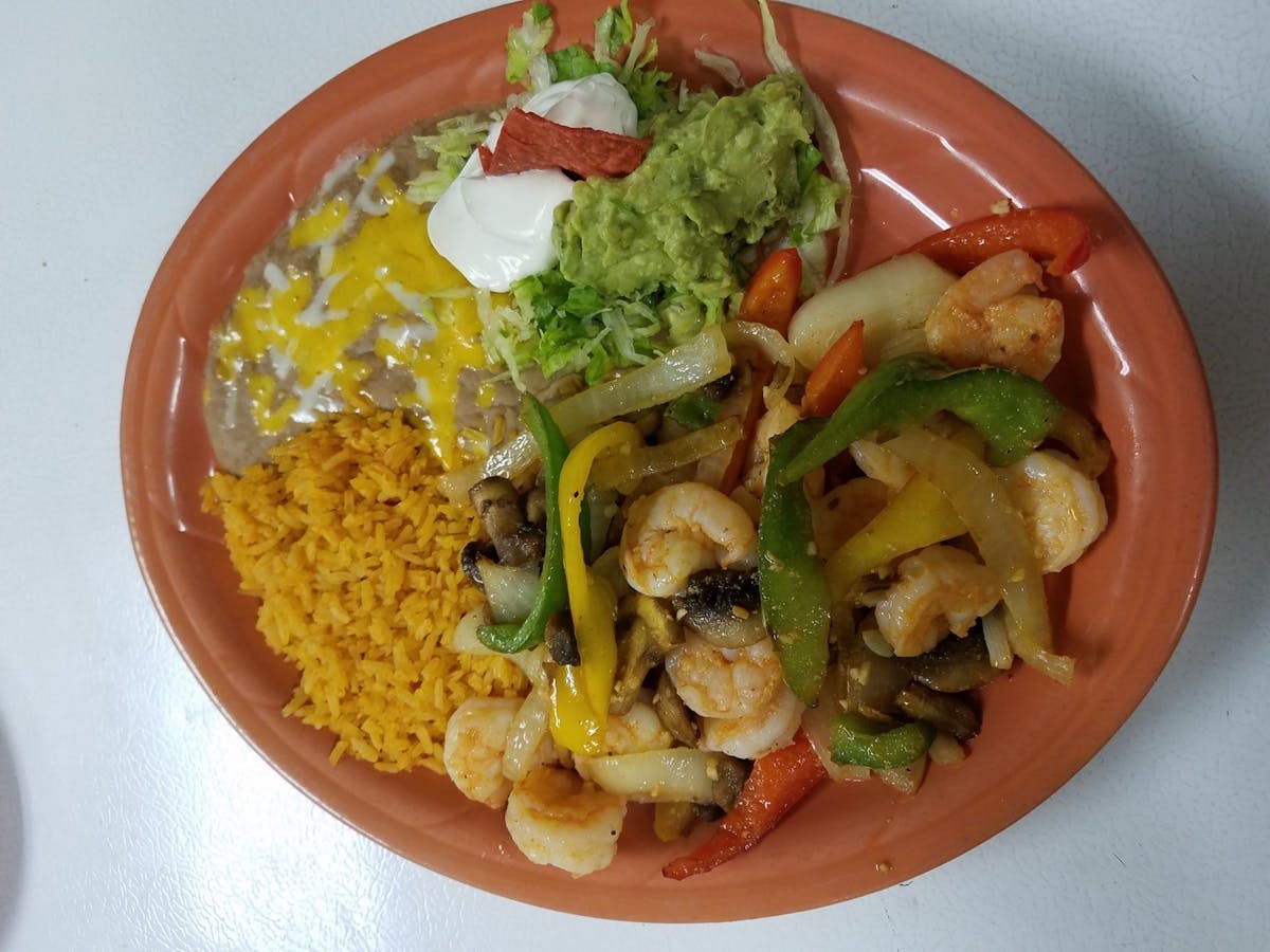 a photo of a plate of food with shrimp and rice and beans