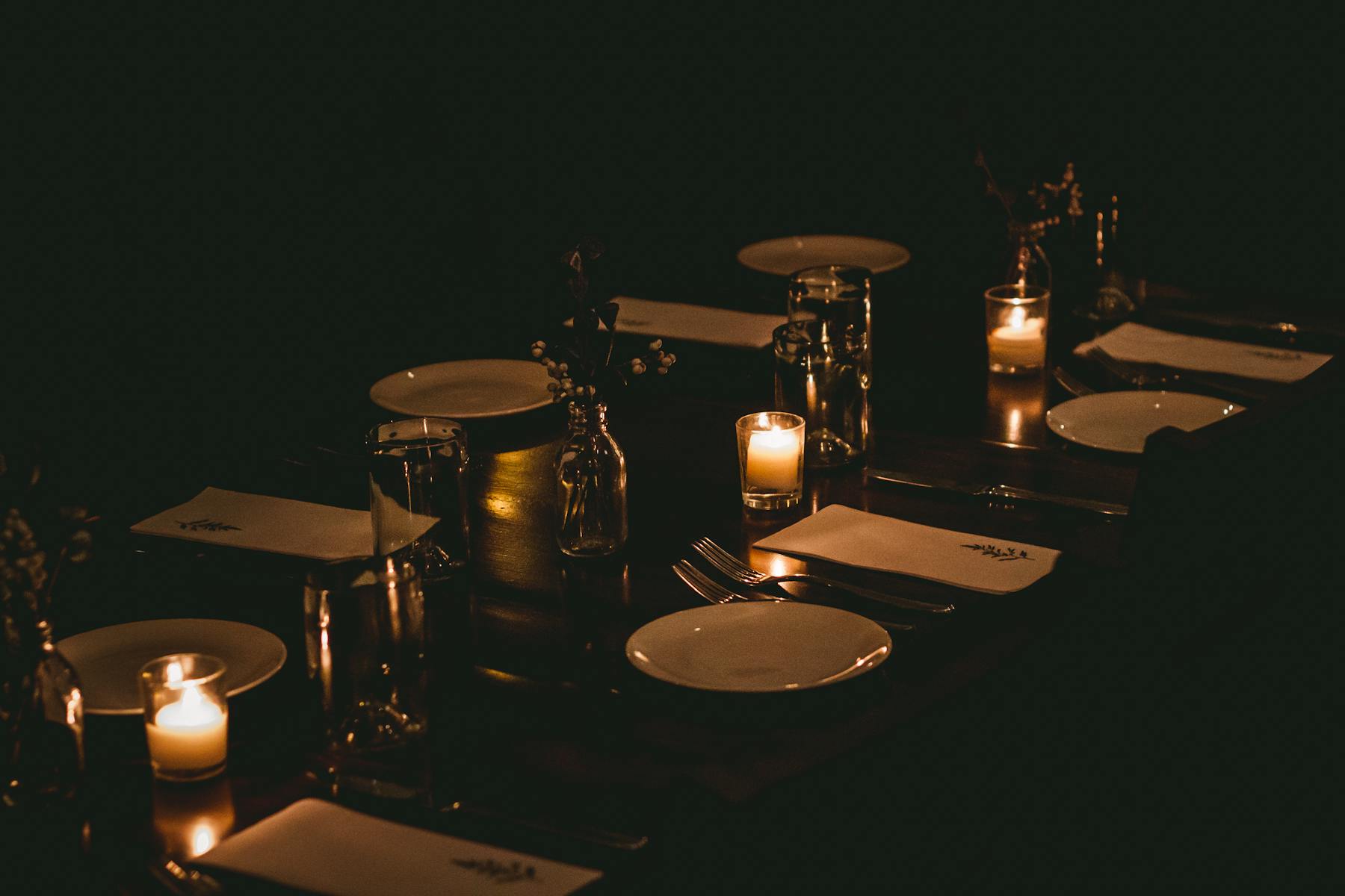 a glass of wine in a dark room