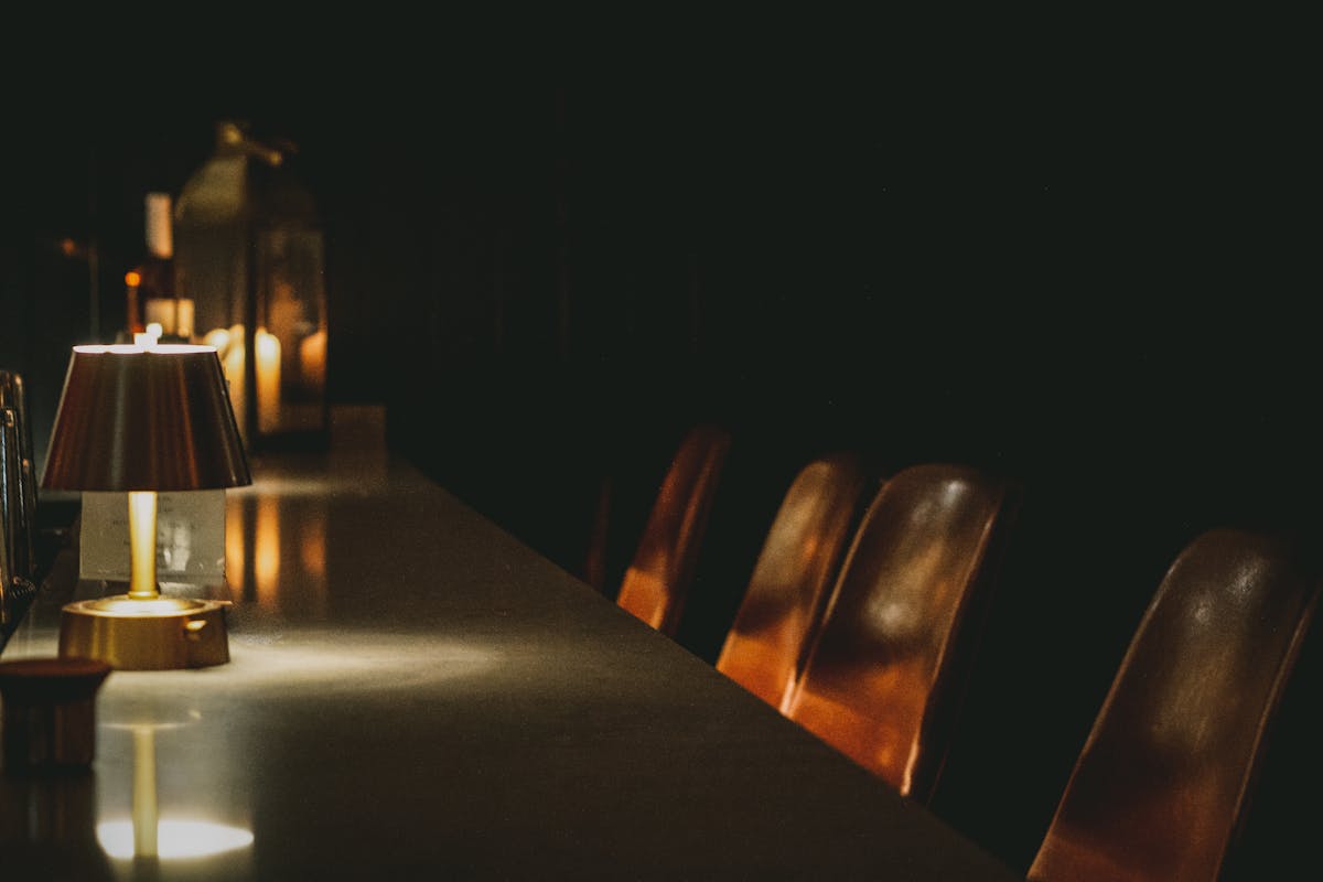 a person sitting at a table in a dark room