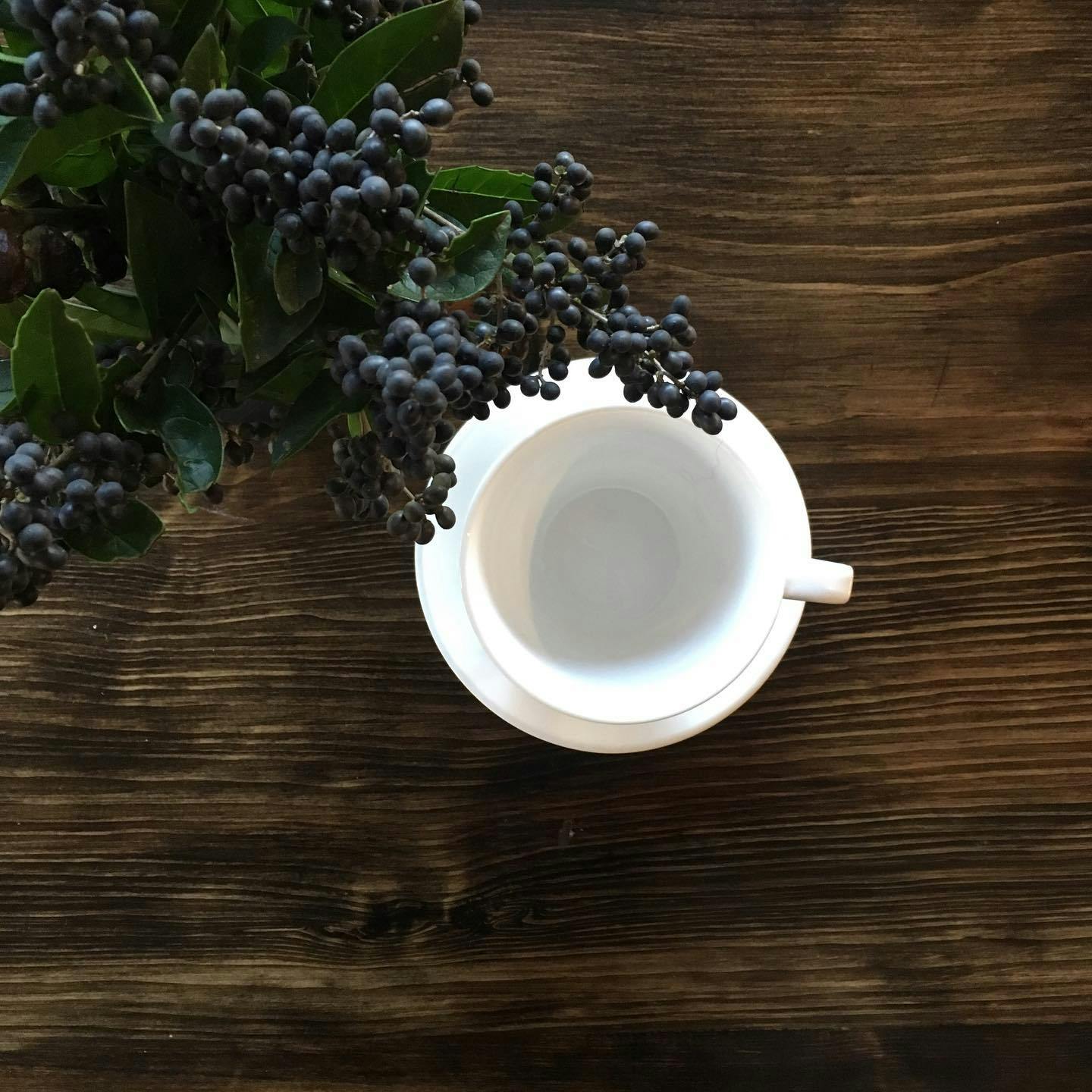 a wooden table with a cup in the middle