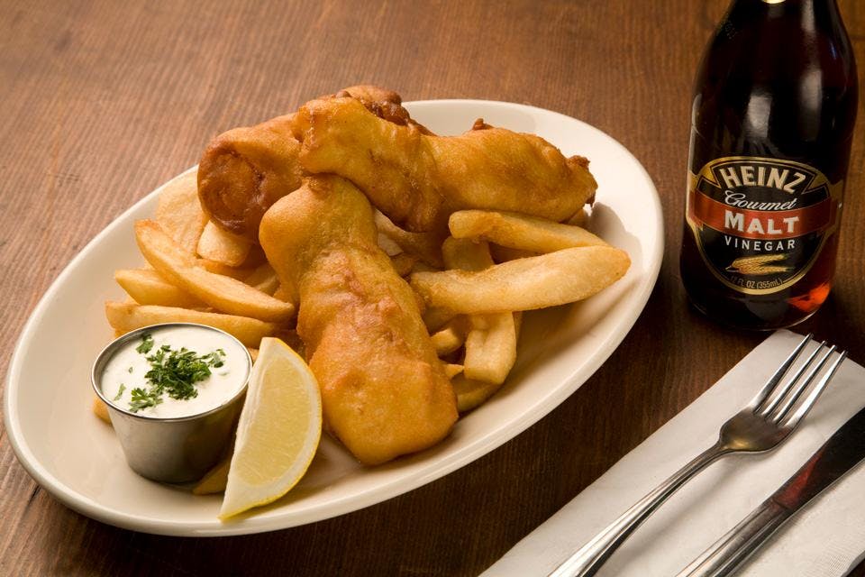 a plate of food and a bottle on a table