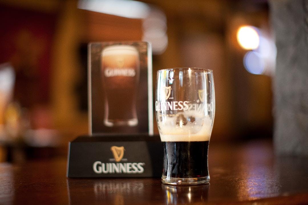 a close up of a glass of beer on a table