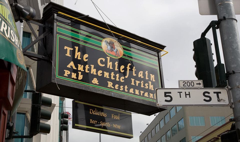 a street sign hanging off the side of a building