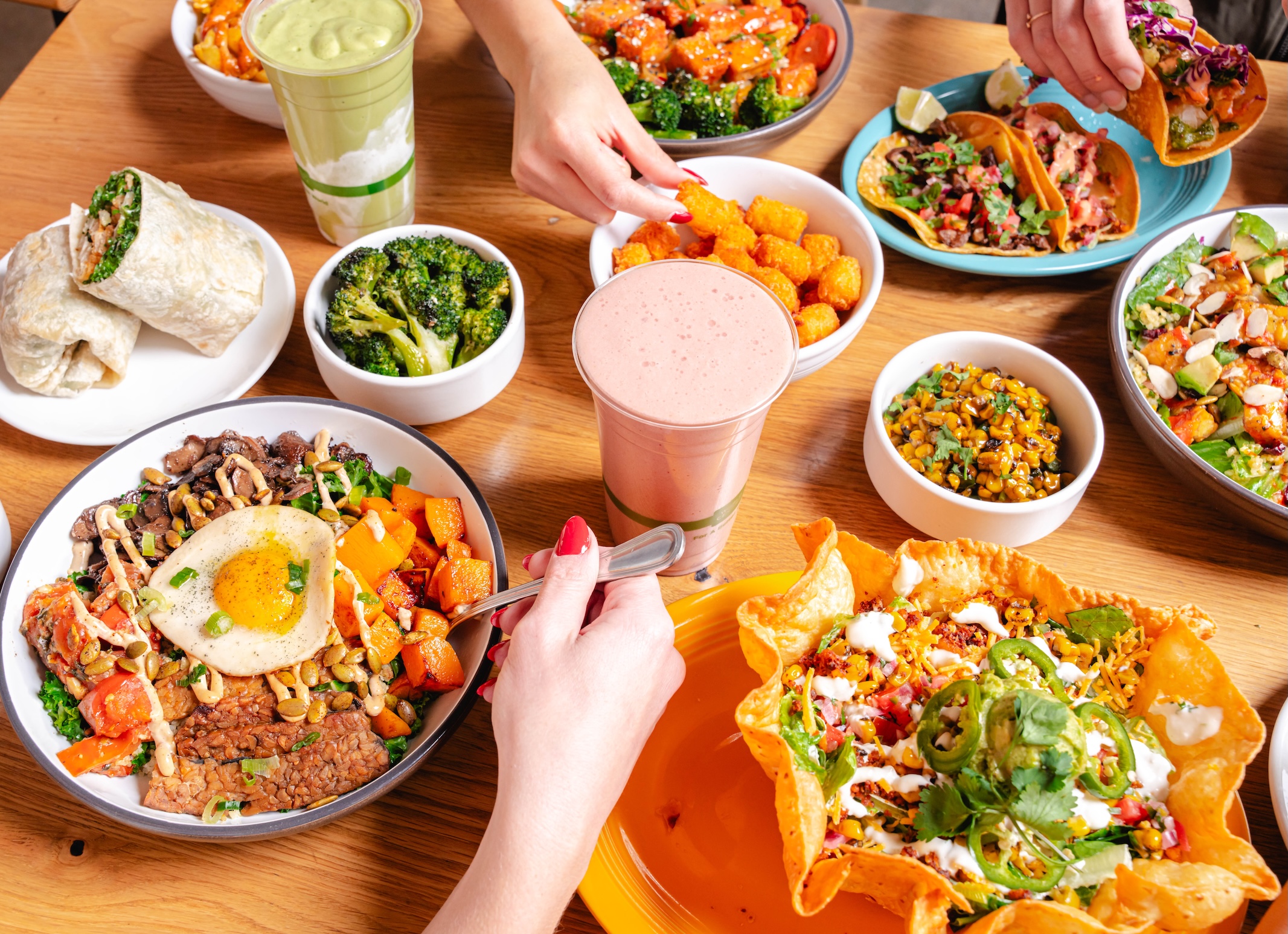 a group of people sitting at a table with a plate of food