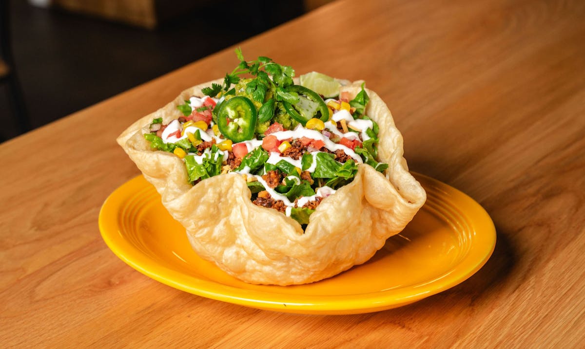 a plate of food sitting on top of a wooden table