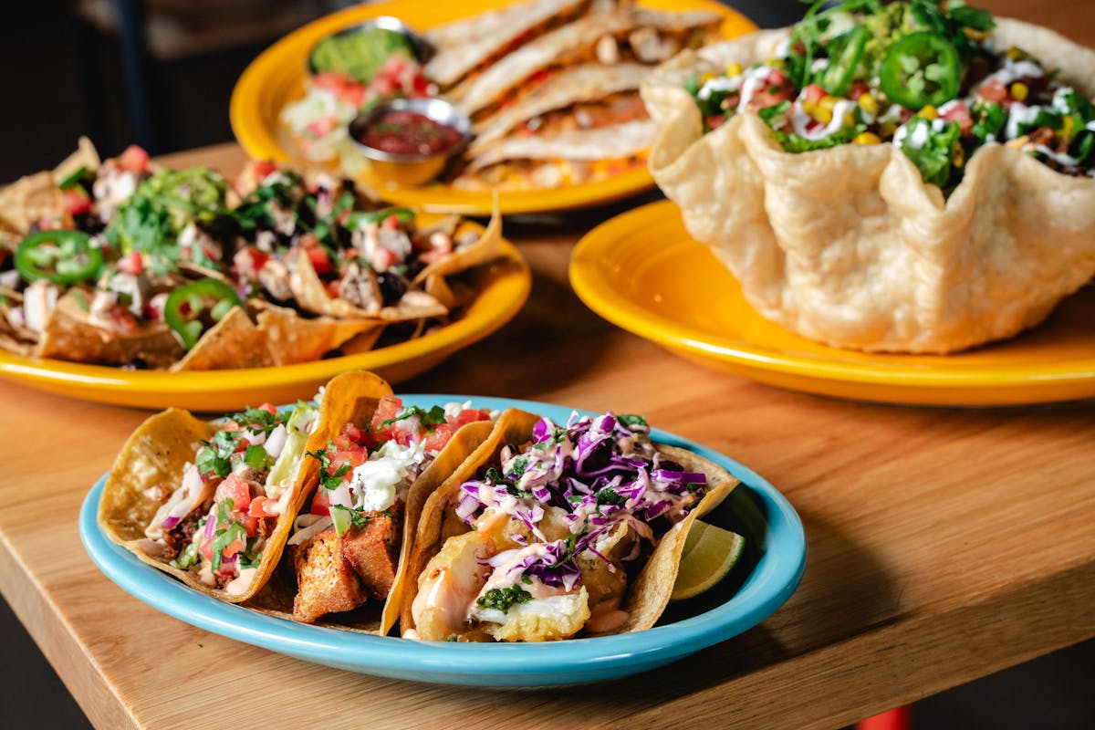 a plate full of food sitting on top of a wooden table