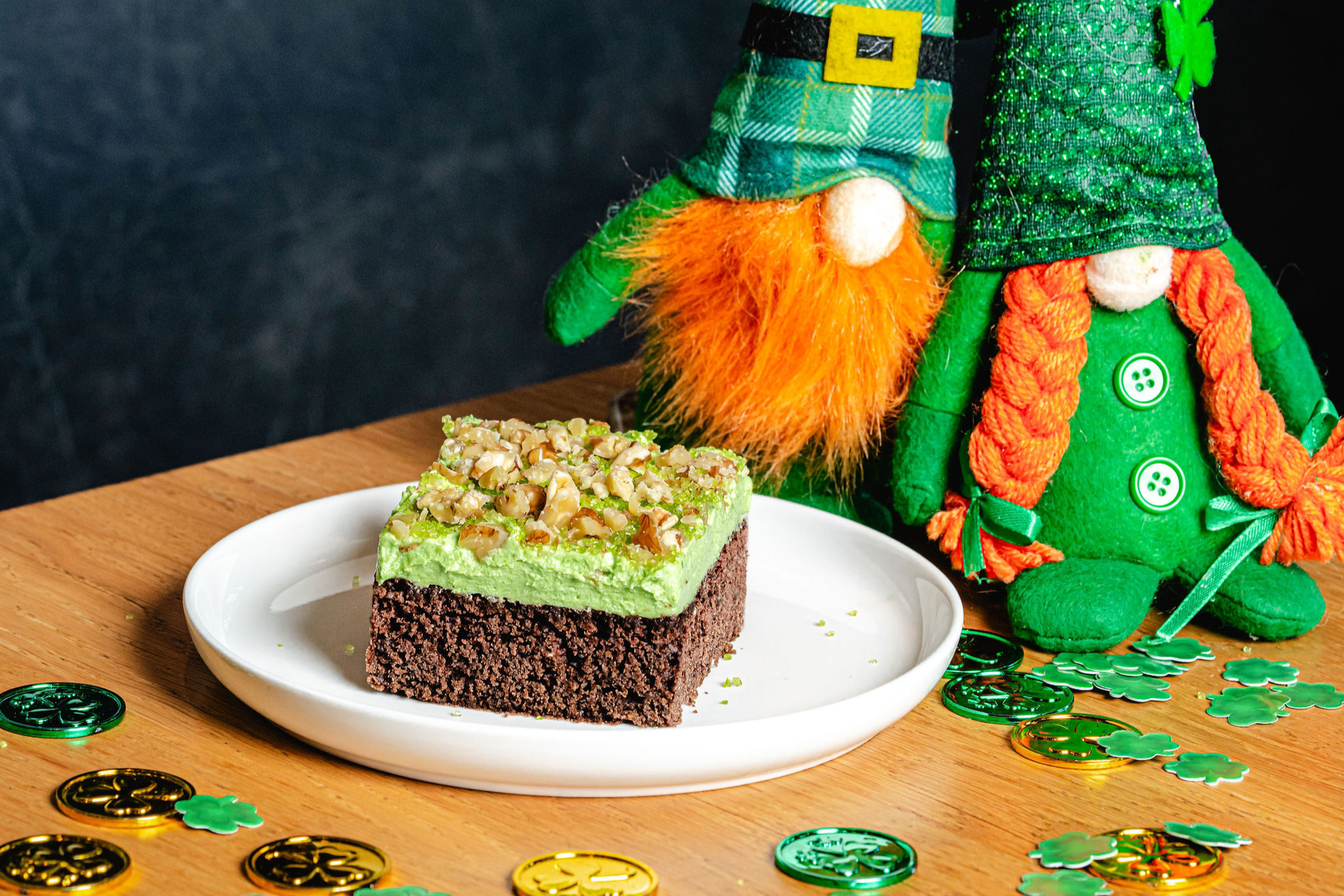 Lucky Leprechaun Velvet Cake topped with walnuts, surrounded by festive St. Patrick’s Day decorations.