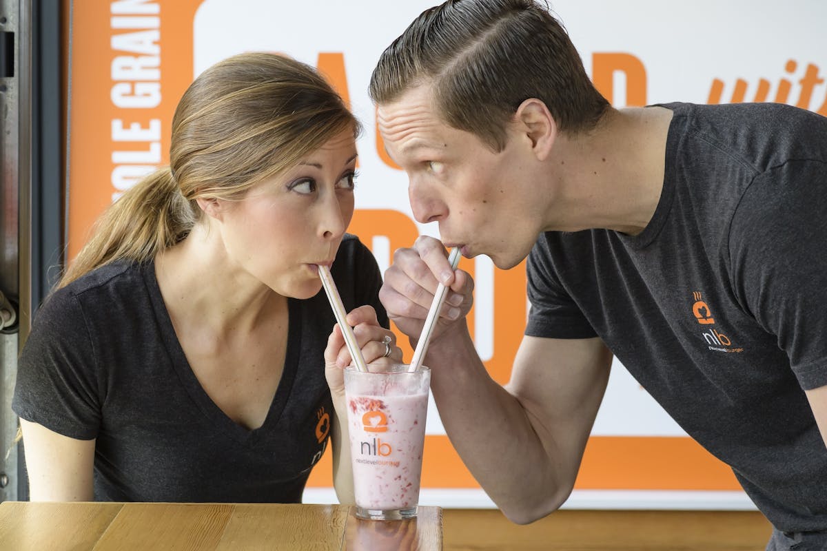 Matt and Cierra de Gruyter sipping a shake with two straws