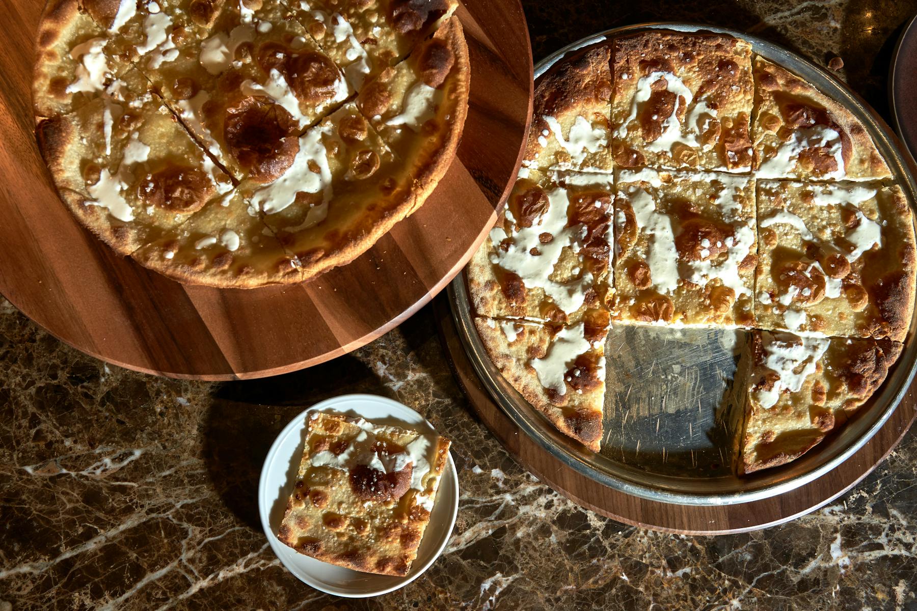 a pizza sitting on top of a wooden table