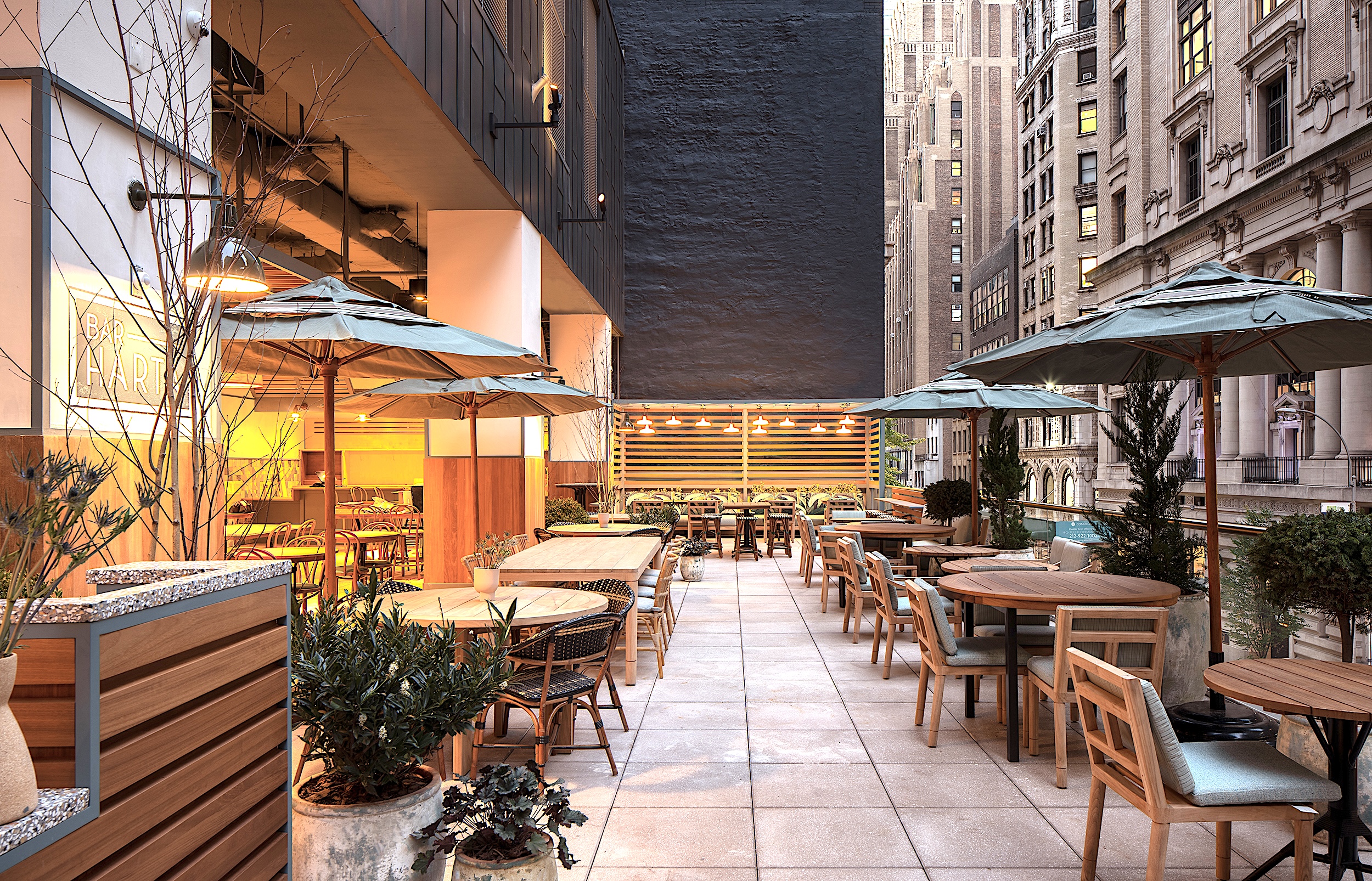 a patio with tables and umbrellas