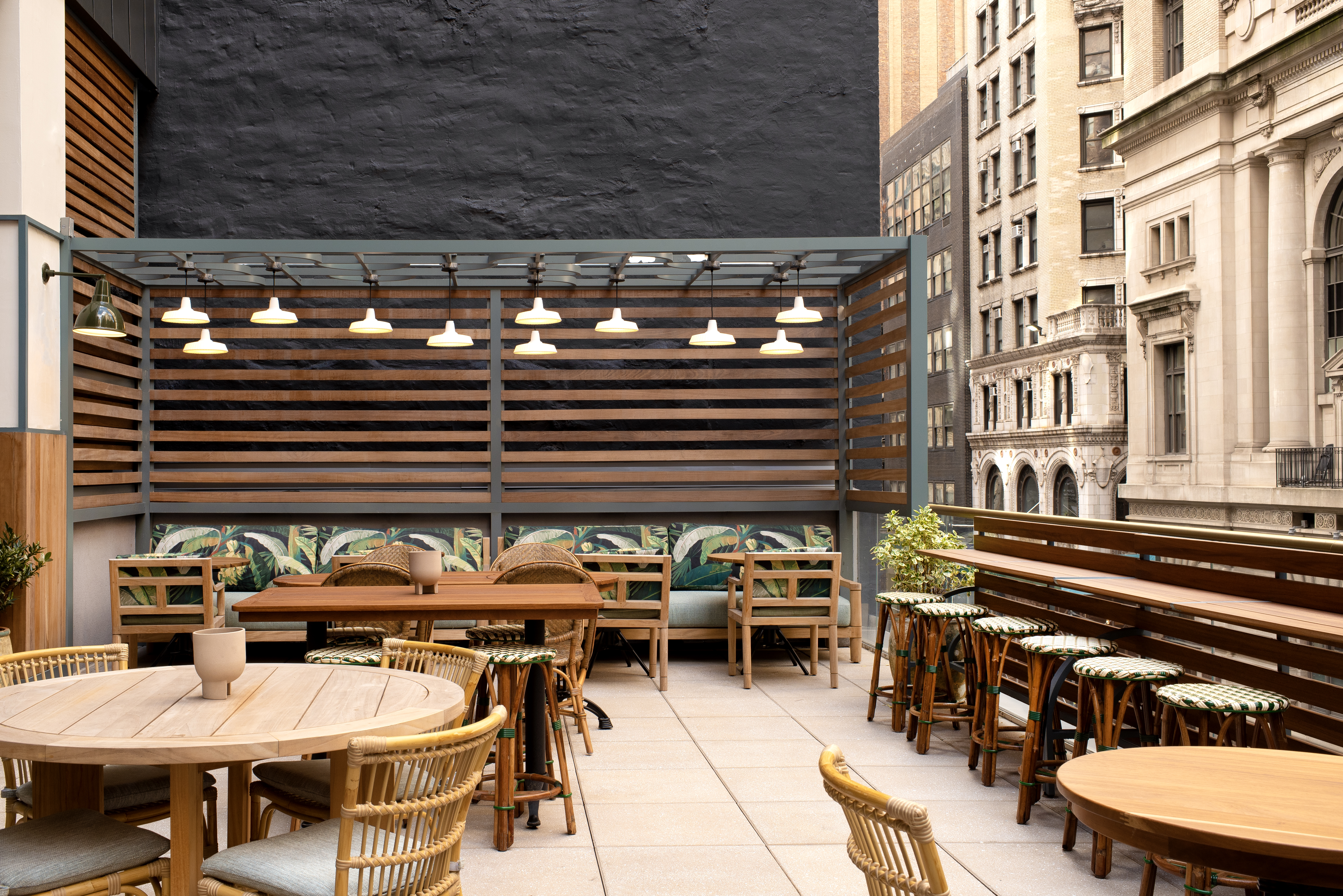 a group of people sitting at a table in front of a building
