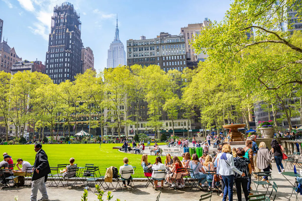 a group of people sitting in chairs in a park
