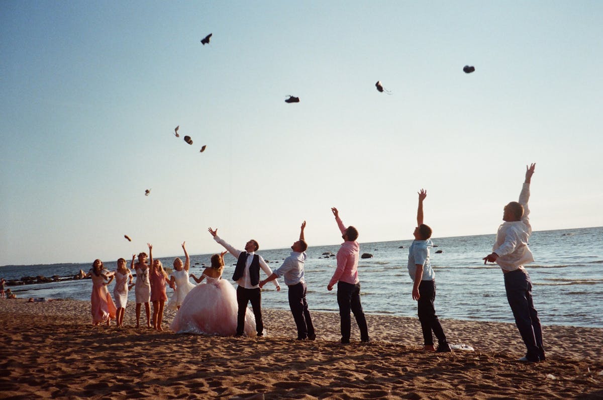 a group of people flying kites on a beach