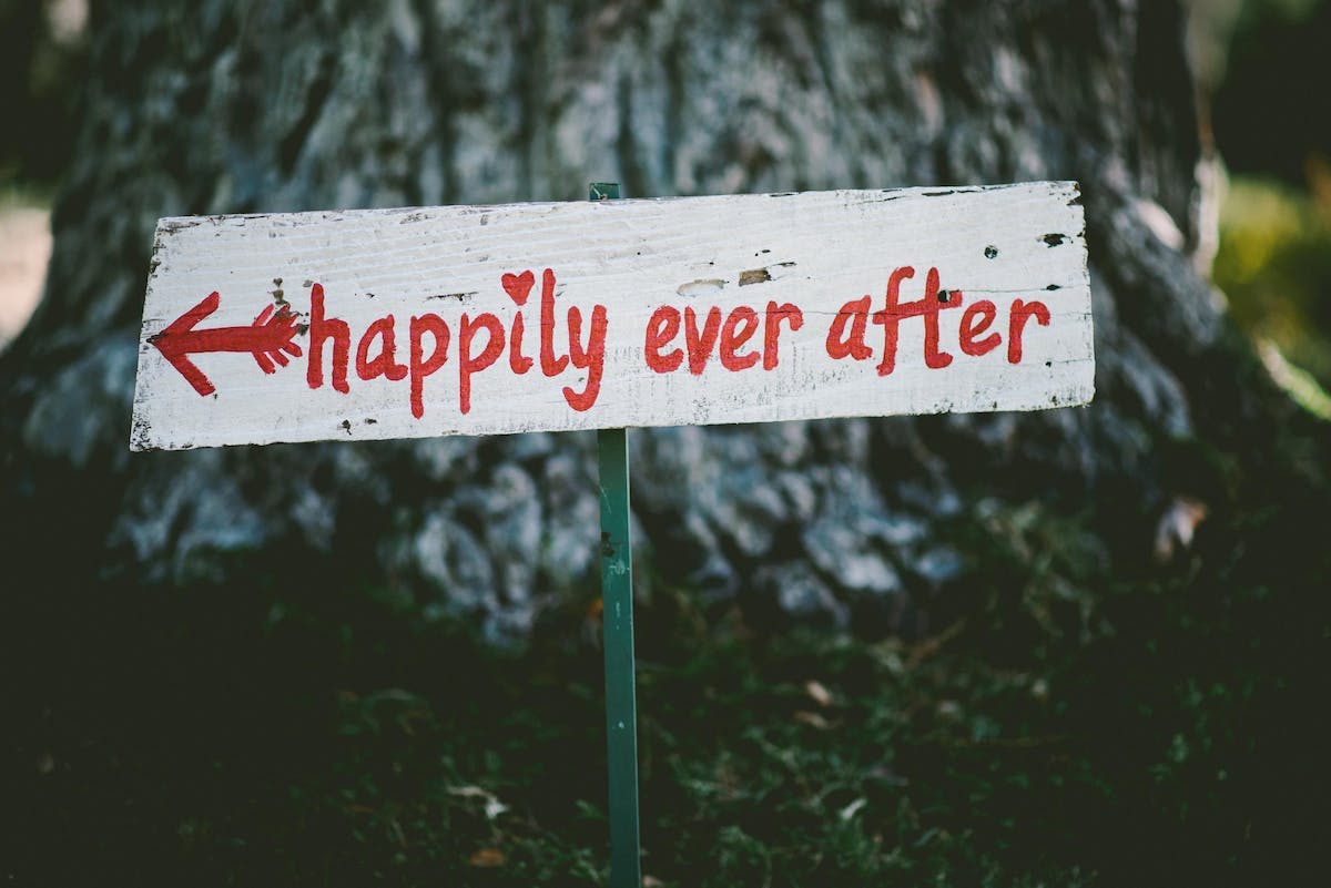 a sign in front of a tree