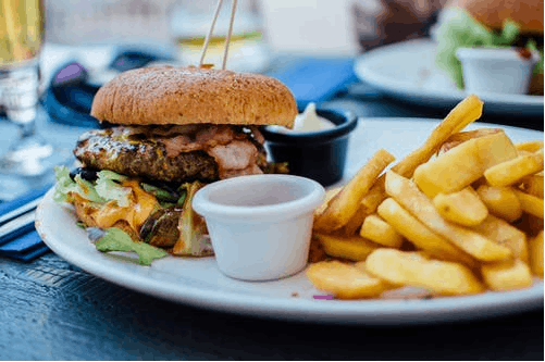 burger, fries, and dip on a plate