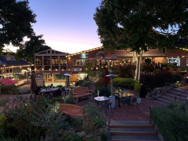 Lights illuminating the outdoor seating area of a restaurant 