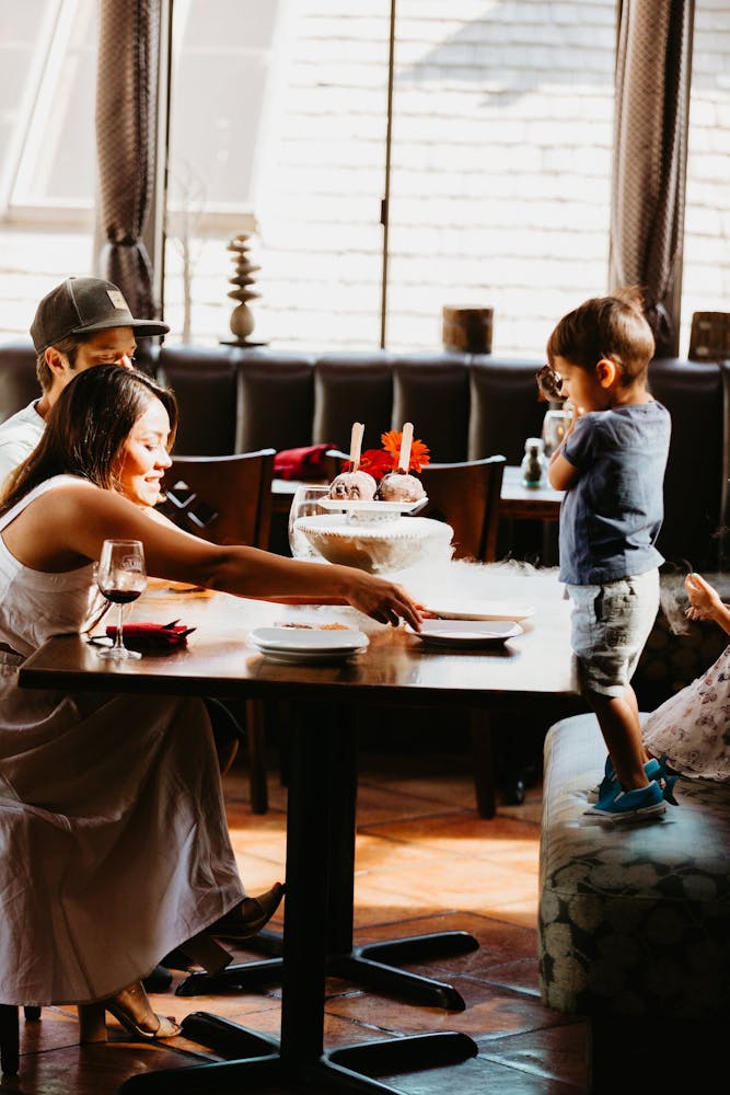 A family enjoying a meal at a fine dining restaurant in Carmel, CA