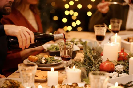 A setting of candles and wine on a table