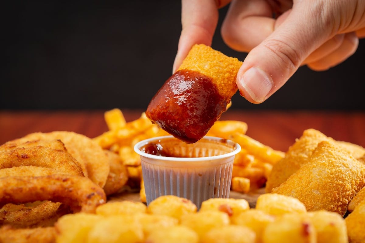 Fried chicken dipped in red sauce