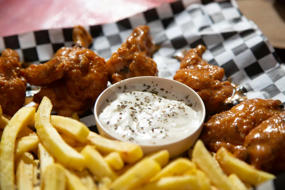 Fried chicken and fries around a dip