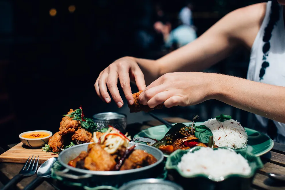 Person holding fried chicken