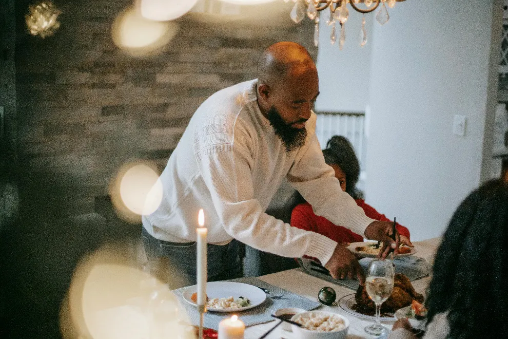 Man cutting up roasted chicken