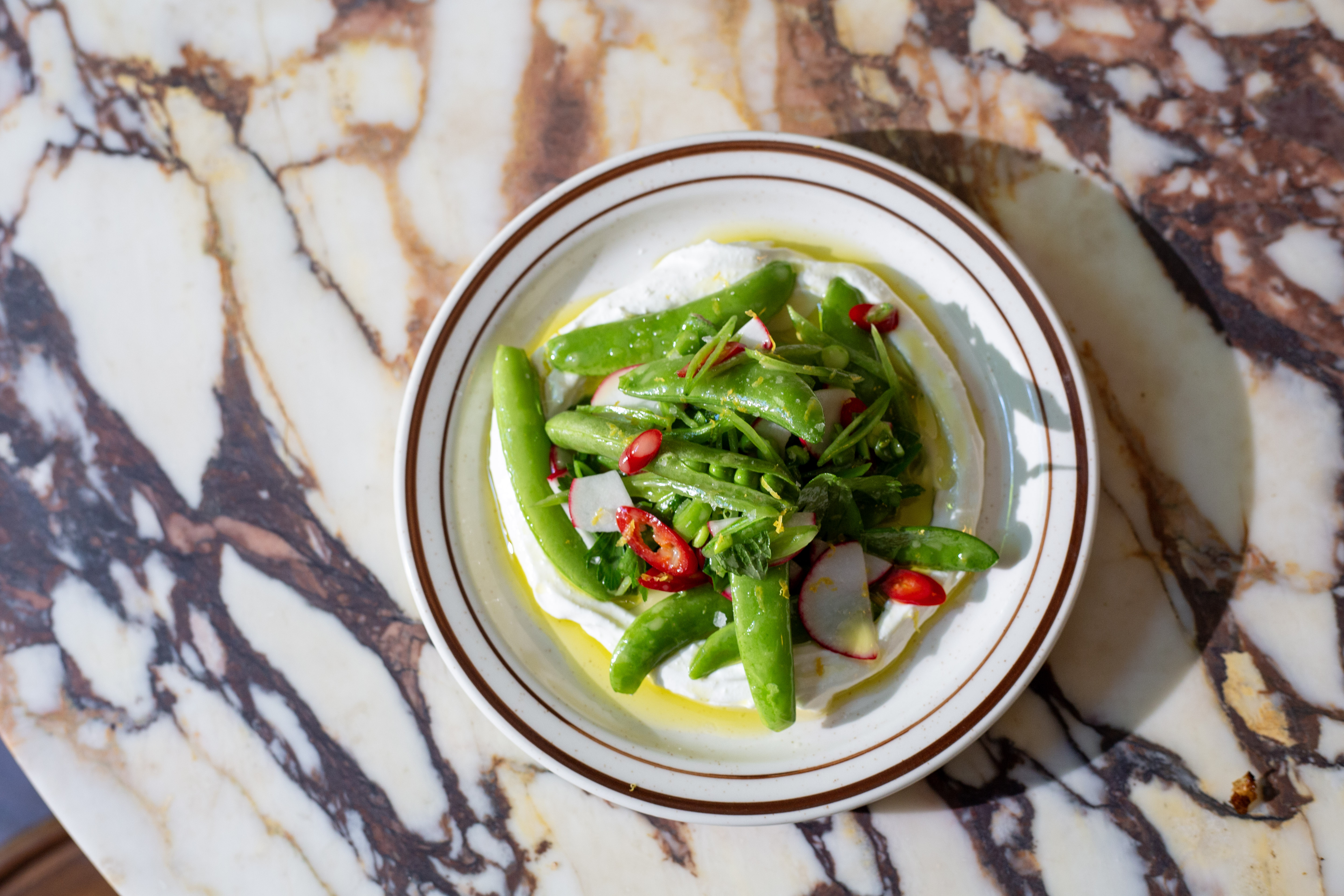 a plate of food on a marble surface