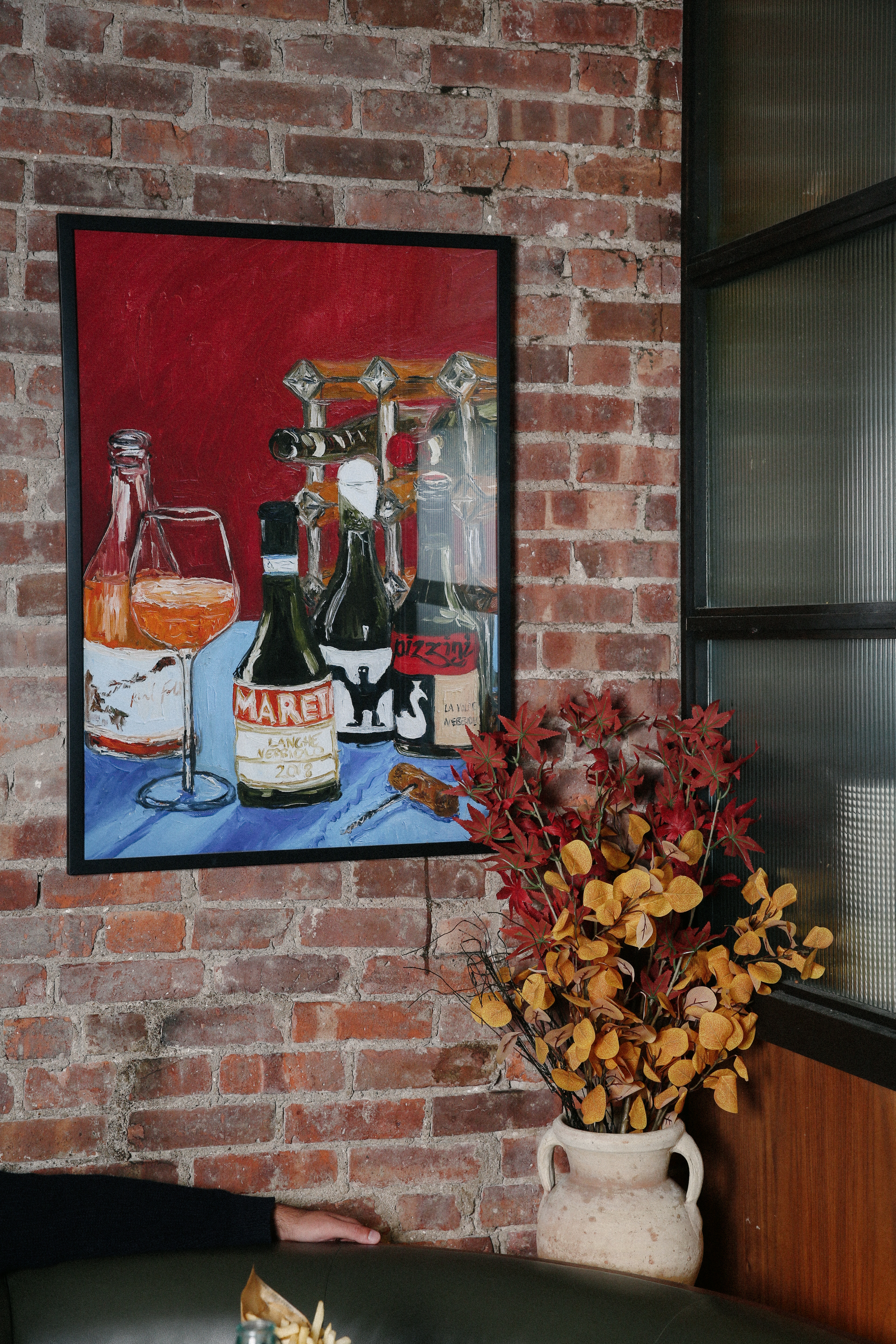 a vase of flowers on a brick wall