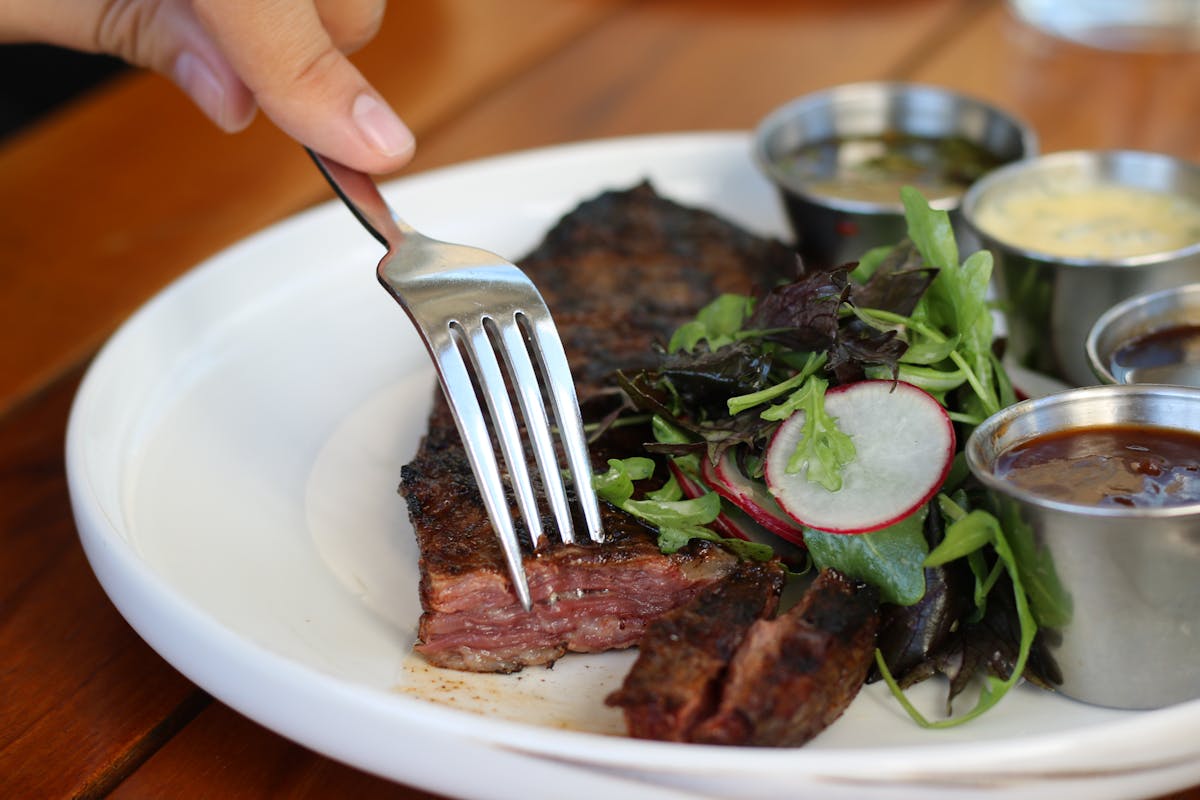 steak and salad on a plate at Edge Steak & Bar in Brickell, Miami